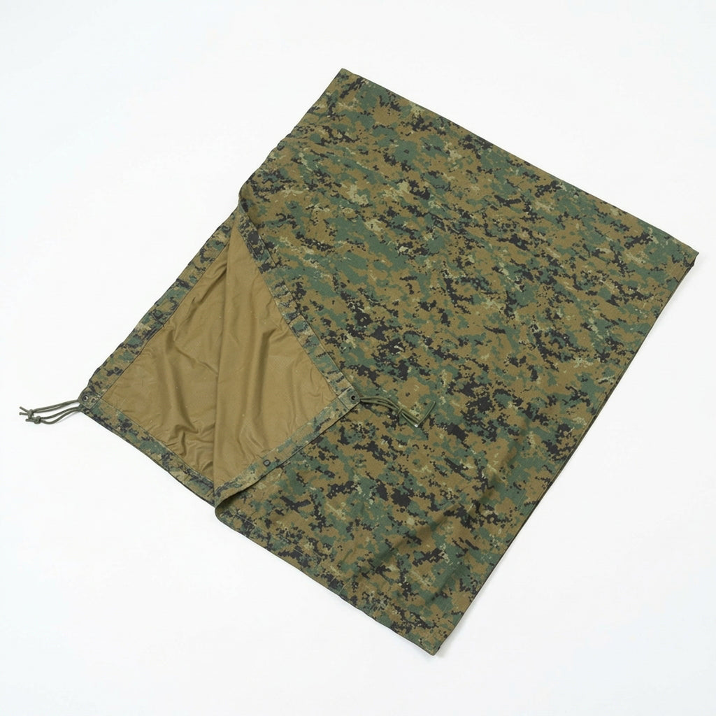 A camouflage military-style blanket or sleeping bag cover shown flat on a white background, with the interior lining visible on one folded section.