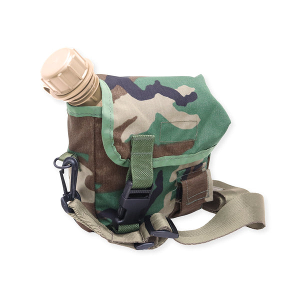 A camouflage utility pouch with a green flap and a beige bottle cap protruding from the top, shown on a plain white background.