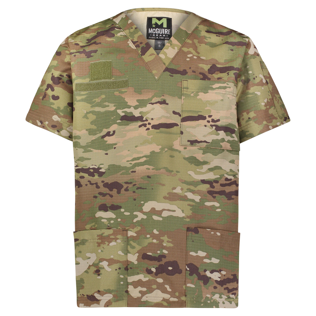 A short-sleeve scrub top in a Multicam camouflage pattern, featuring a V-neck, a chest pocket, and two large front utility pockets, shown against a plain white background.