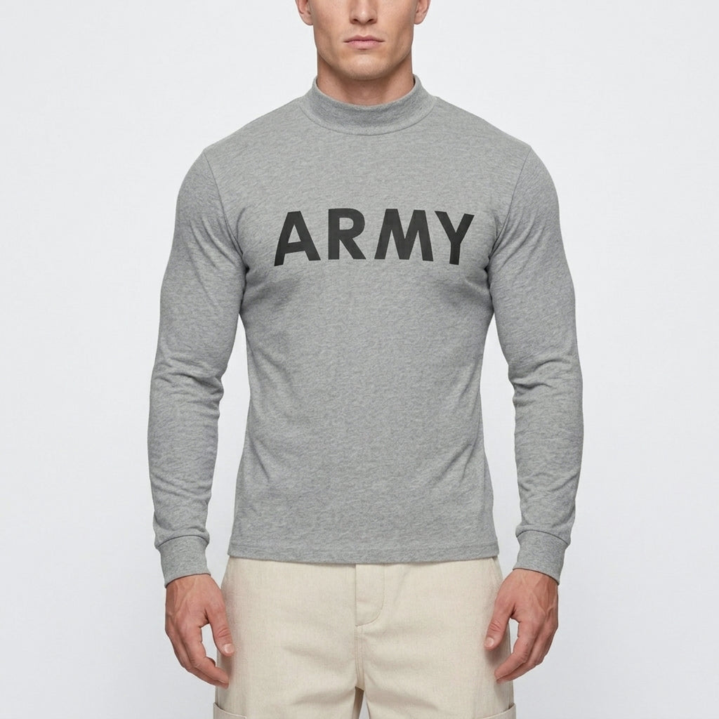 A man wearing a heather gray long-sleeve mock neck shirt with the word 'ARMY' printed in black across the chest, paired with light beige pants, against a plain light gray background.